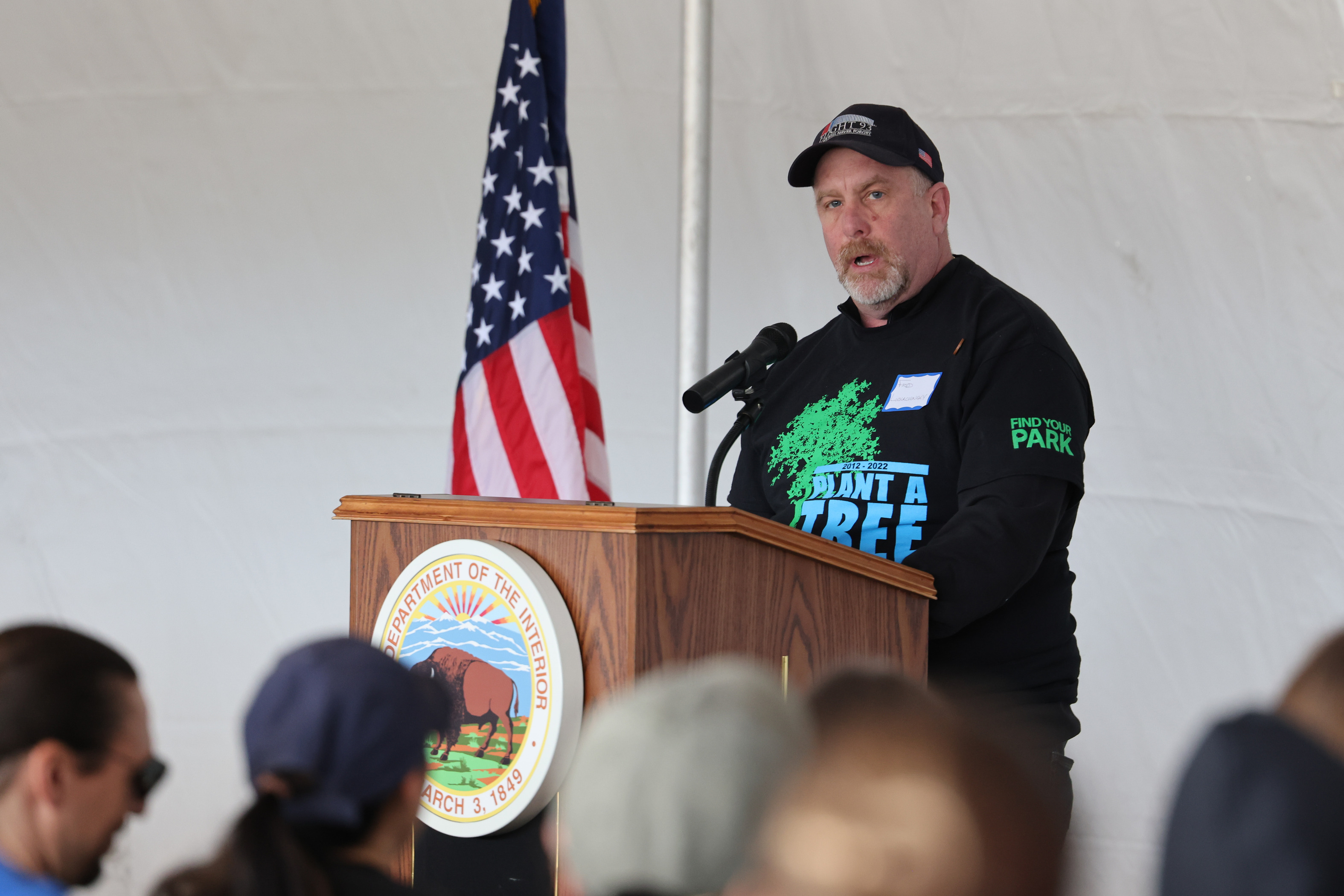 Fred Lukachinsky speaking at a podium.