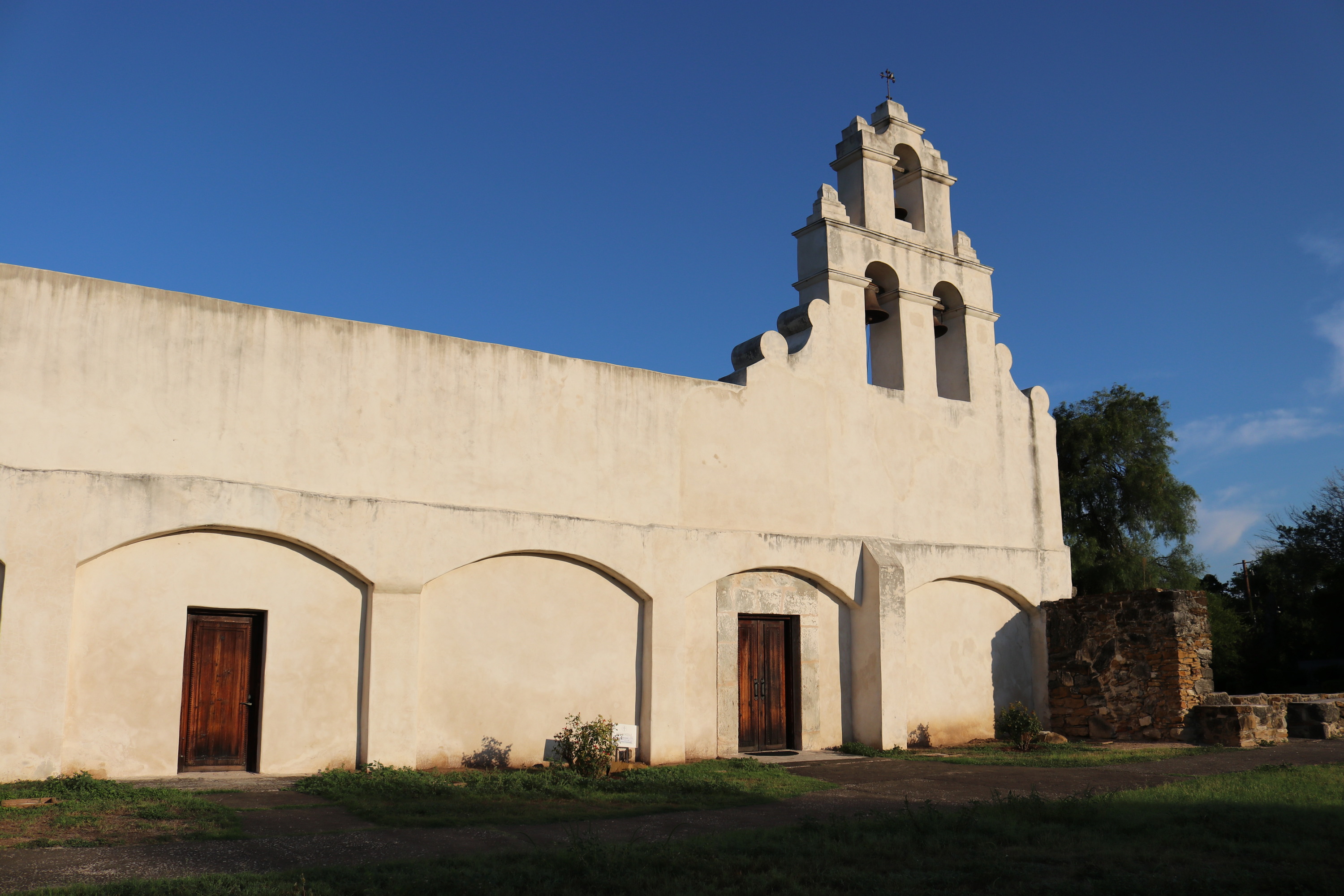Front of Mission San Juan Church with a clear blue sky above. 
