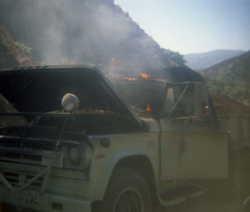 Color photo of an engine fire in a pickup.
