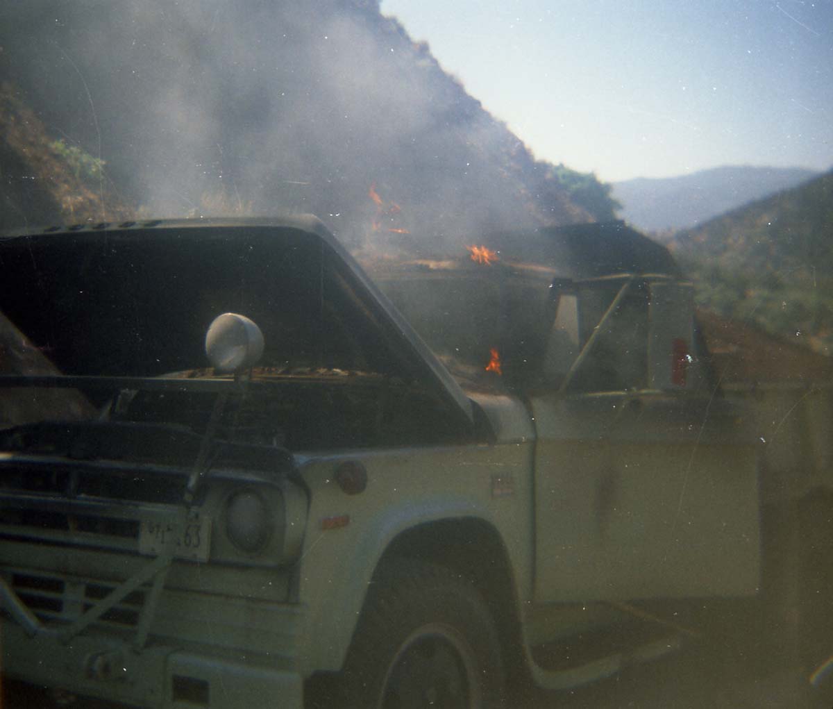 Color photo of an engine fire in a pickup.