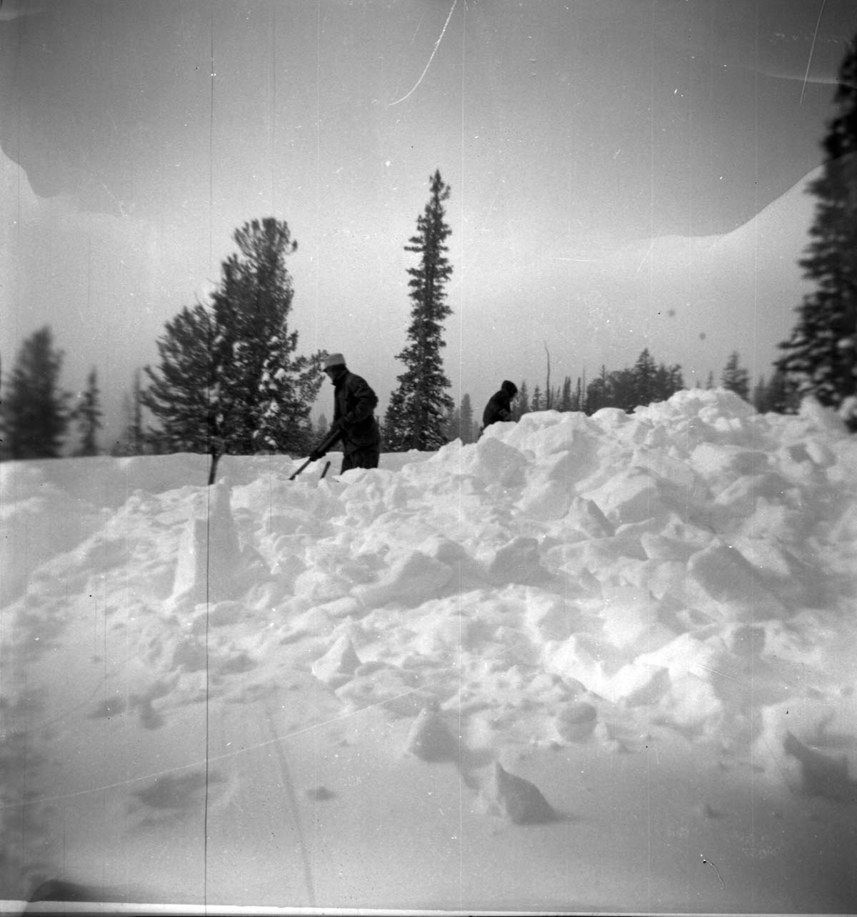 BW Photos showing rangers digging out the visitor center from snowdrift.