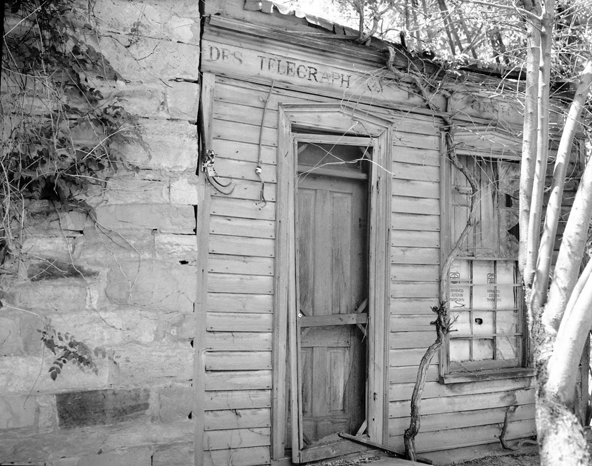 The Deseret Telegraph Company telegraph office in Rockville, Utah. Sign reads: Des Telegraph. Style of print for sign at Pipe Spring National Monument.
