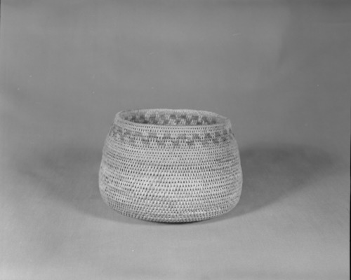 Private Collection. Object: Miwok basket. Dimensions: 6 1/4 x 4 1/2". Materials: Bull pine and bracken fern. Technology: Overstitched clockspring start, most increases in diameter attained by double stitching in one hold, very few split stitches used for same purpose. Rim stitched once more around. Collection History: Purchased from Maggie Longfellow's mother, also known as Mrs. Longfellow Poncho. Photographed by Michael Dixon. Catalogued by Craig Bates and Barbara Beroza. Yosemite Collections, National Park Service.