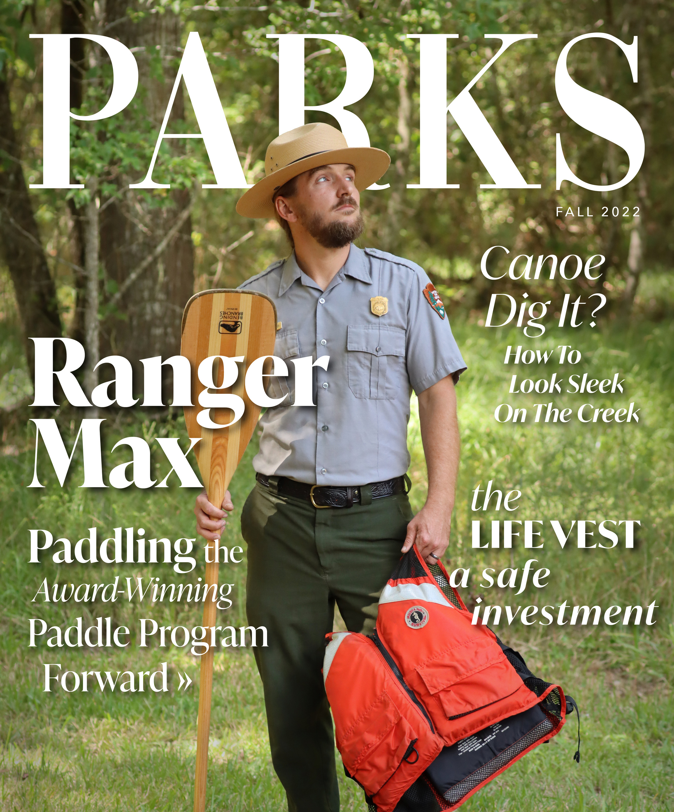 PARKS magazine cover with a park ranger holding a wooden paddle and orange life vest. Text reads: Ranger Max: Paddling the award-winning paddle program forward; Canoe dig it? How to look sleek on the creek; the life vest: a safe investment