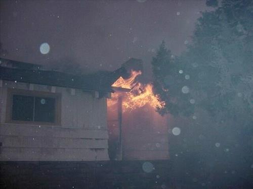 Night photos of a house burning during the Long Mesa fire in Mesa Verde National Park, July-August 2002
