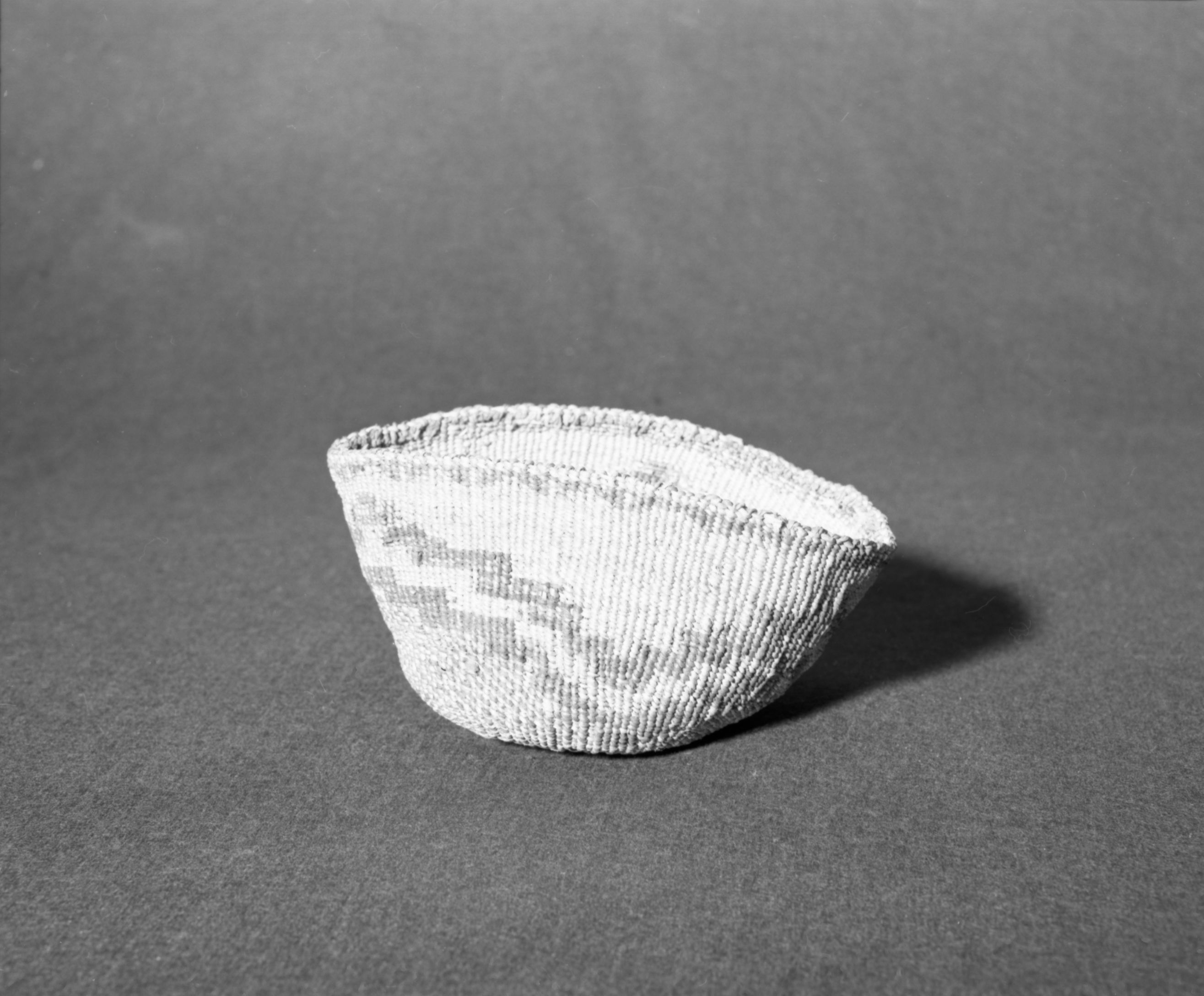 Marie Rozier Collection, Catalog No. 83. Object: Klamath/Modoc basket. Dimensions: 7" x 4 1/2". Materials: made entirely of tule stalk sheath. Collection History: Mrs. Kipling collection. Photographed by Michael Dixon, December 1982. Catalogued by Craig Bates and Barbara Beroza. Yosemite Collections, National Park Service.