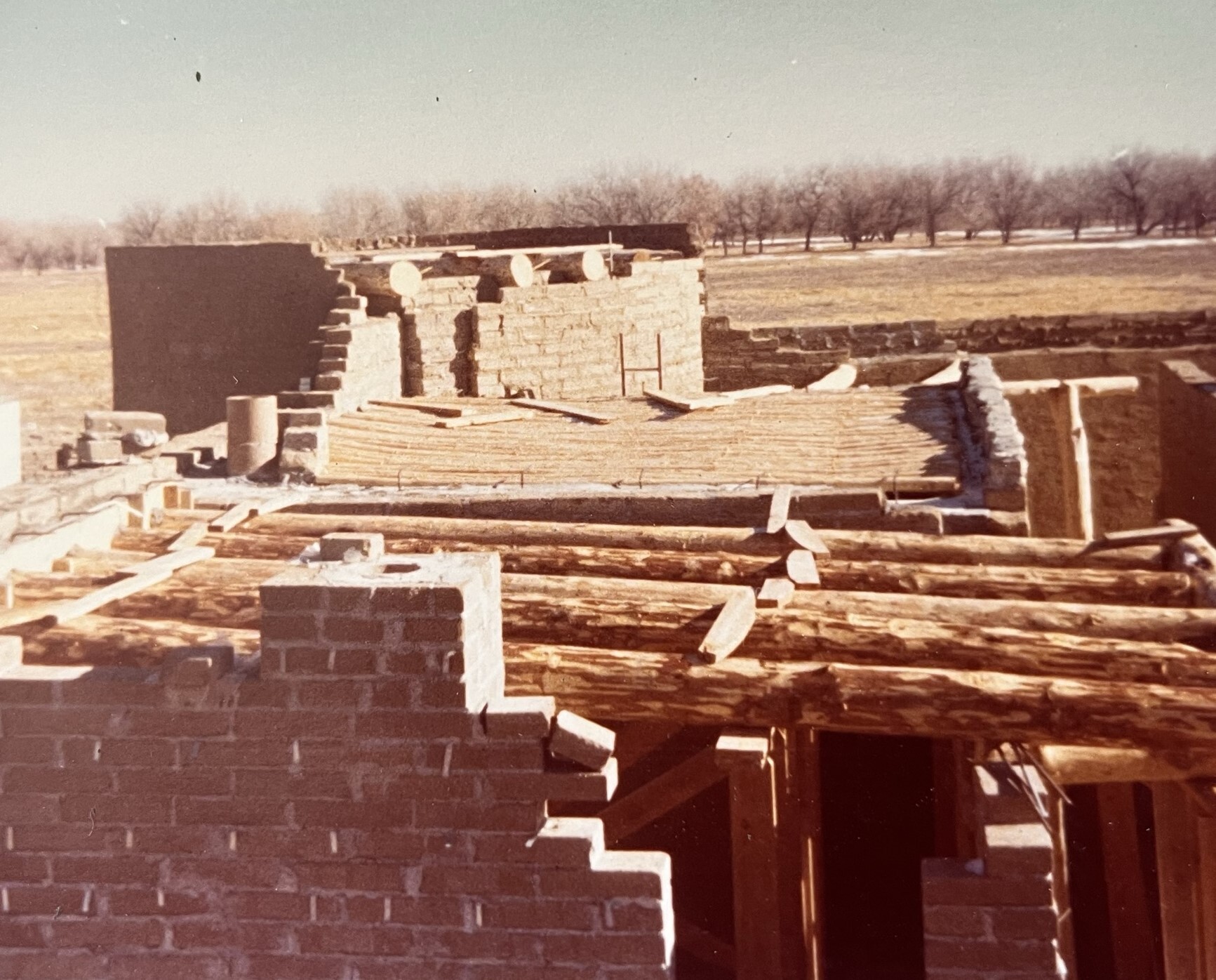 Cottonwood viga beams line the ceilings of two rooms and the distant front bastion. 