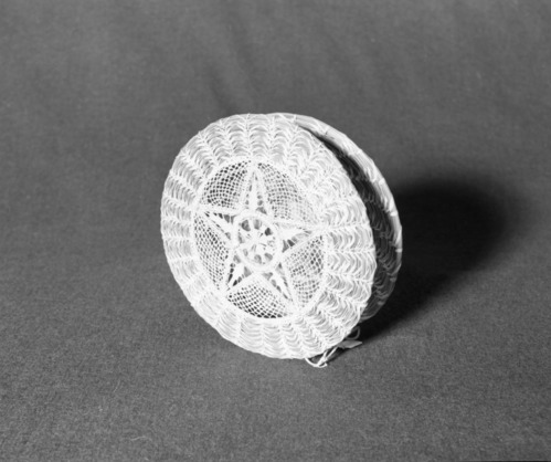 Marie Rozier Collection, Catalog No. 264. Object: Napkin holder. Dimensions: 7 1/2" height. Materials: pine needles, raffia, wire. Collection History: Made by Thyllie Wolf. Purchased for $20. Photographed by Michael Dixon, December 1982. Catalogued by Craig Bates and Barbara Beroza. Yosemite Collections, National Park Service.