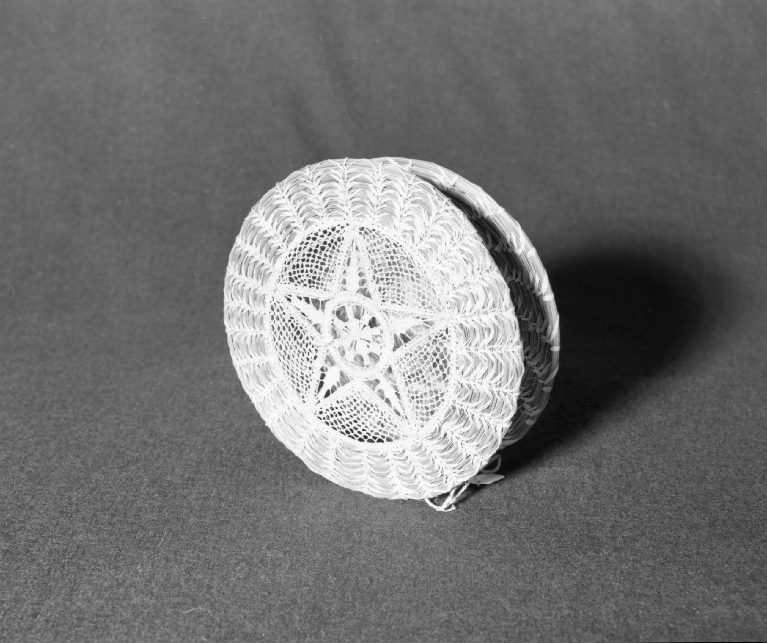 Marie Rozier Collection, Catalog No. 264. Object: Napkin holder. Dimensions: 7 1/2" height. Materials: pine needles, raffia, wire. Collection History: Made by Thyllie Wolf. Purchased for $20. Photographed by Michael Dixon, December 1982. Catalogued by Craig Bates and Barbara Beroza. Yosemite Collections, National Park Service.