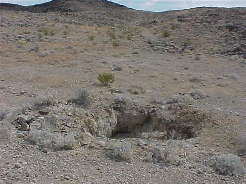 Open shafts and adits at Paymaster Mine, an abandoned gold mine in July 2004.