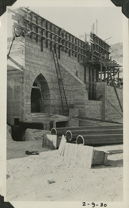 This is an historic black and white photograph from the Scotty's Castle Historic Photograph Collection, Death Valley National Park of southeast view of construction on Scotty's Castle Power House and Pavilion. February 9, 1930. Photographed by Mat Roy Thompson.