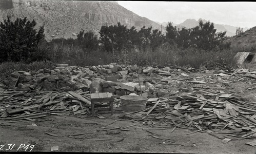 Unsightly conditions such as these occurred along the highway after original owners moved away. Small table, washtub and water spigot are visible among buildings debris.