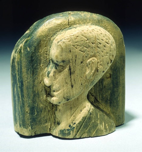 Relief bust portrait of Caesar in profile; top in arch shape