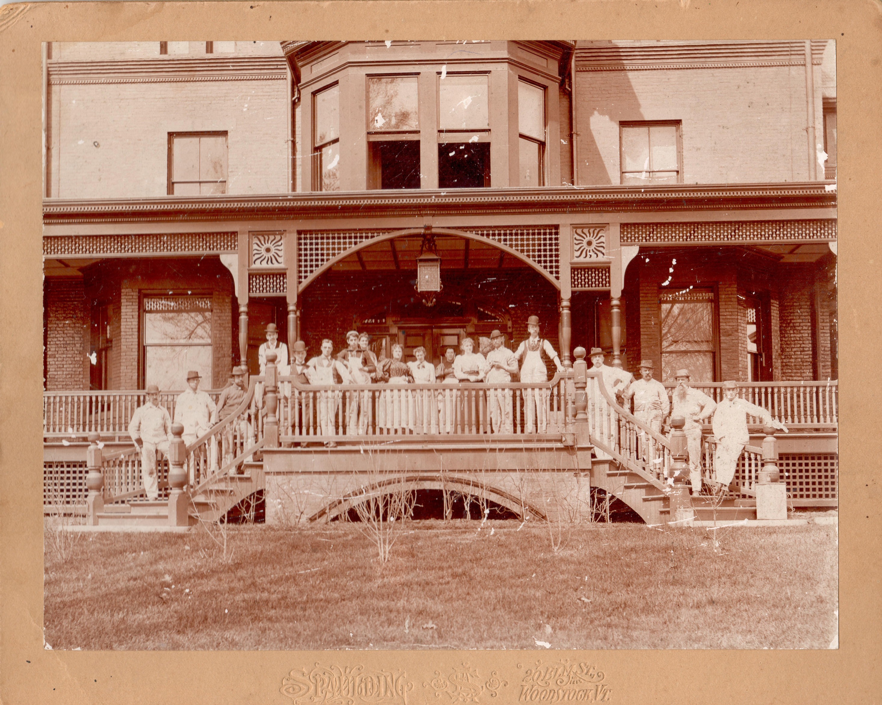 Historic photo of large crew of servants and painters pose on the porch of the Marsh-Billings-Rockefeller mansion