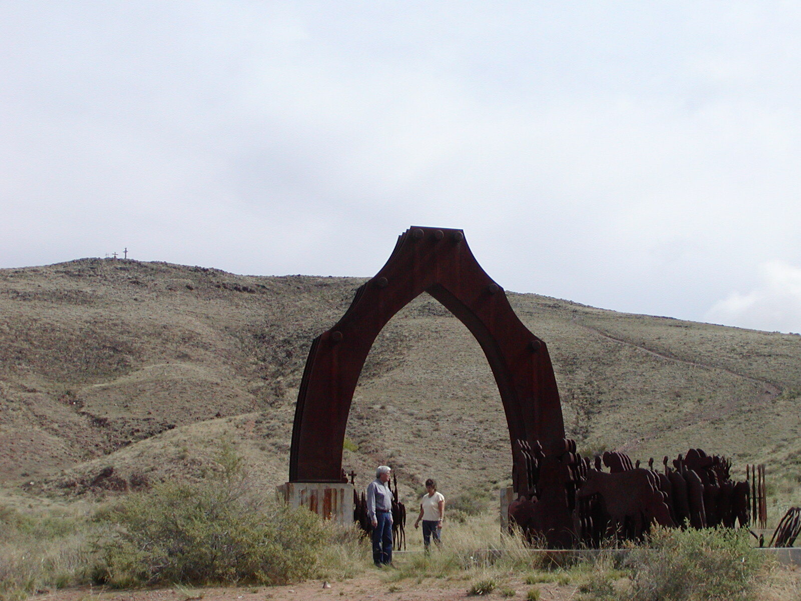 A group admires Puerta del Sol sculpture at El Cerro de Tome in Valencia County, NM