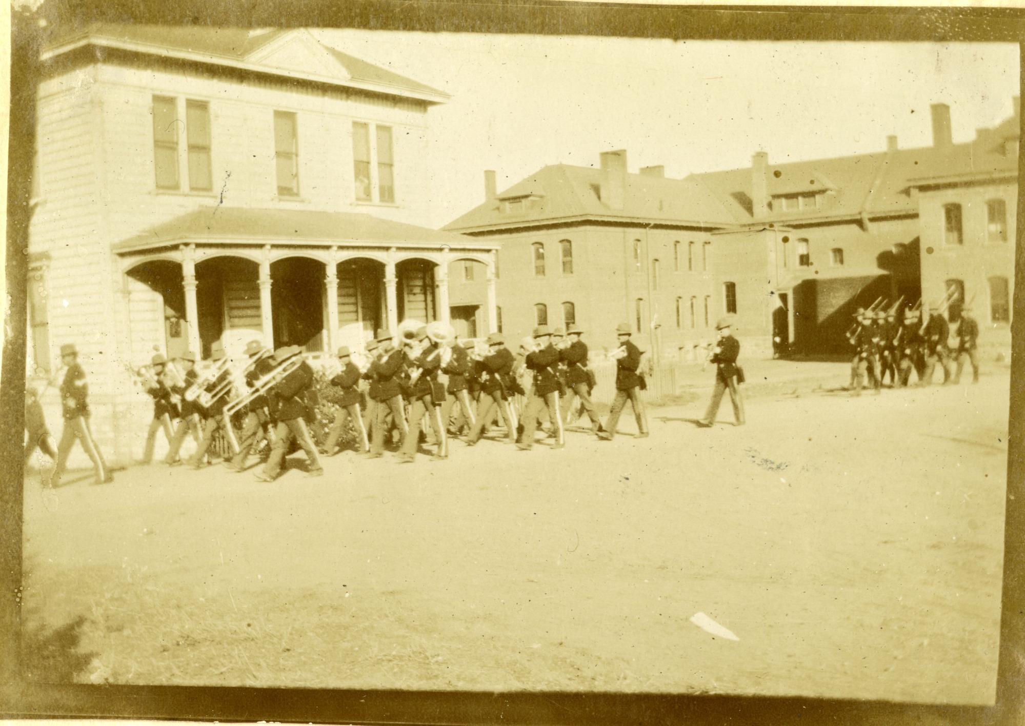 The firing squad and band follow the funeral procession c1899 