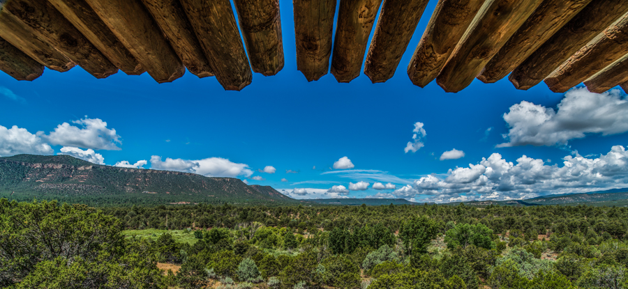 Blue sky with a green mesa on the horizon 