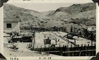 This is an historic black and white photograph from the Scotty's Castle Historic Photograph Collection, Death Valley National Park of Scotty's Castle Hacienda, looking east. First floor concrete poured since photograph a week before. Fire Cache on left. February 19, 1928. Photographed by Mat Roy Thompson.