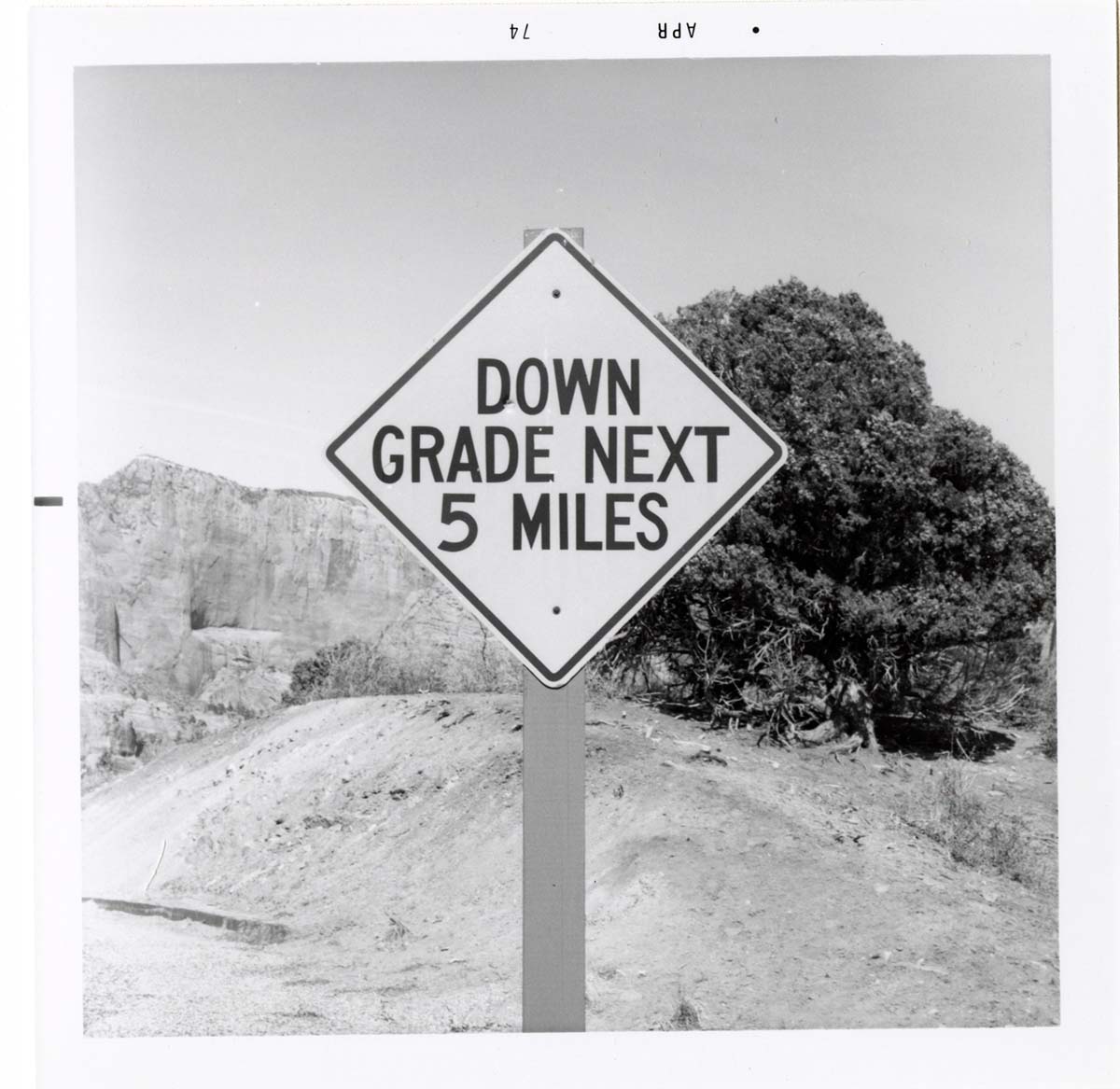 Road sign reading 'Down Grade Next 5 Miles' in Kolob Canyon.