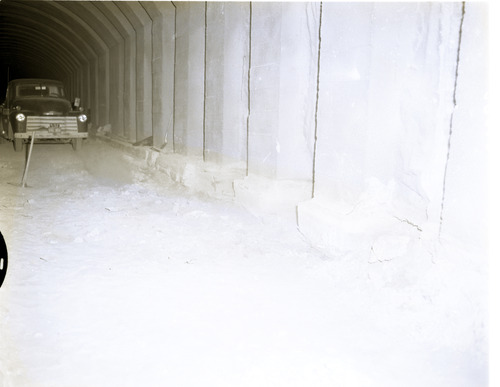 Shattered condition of tunnel wall, illustrating need for repair and danger of work of removing debris from footings.