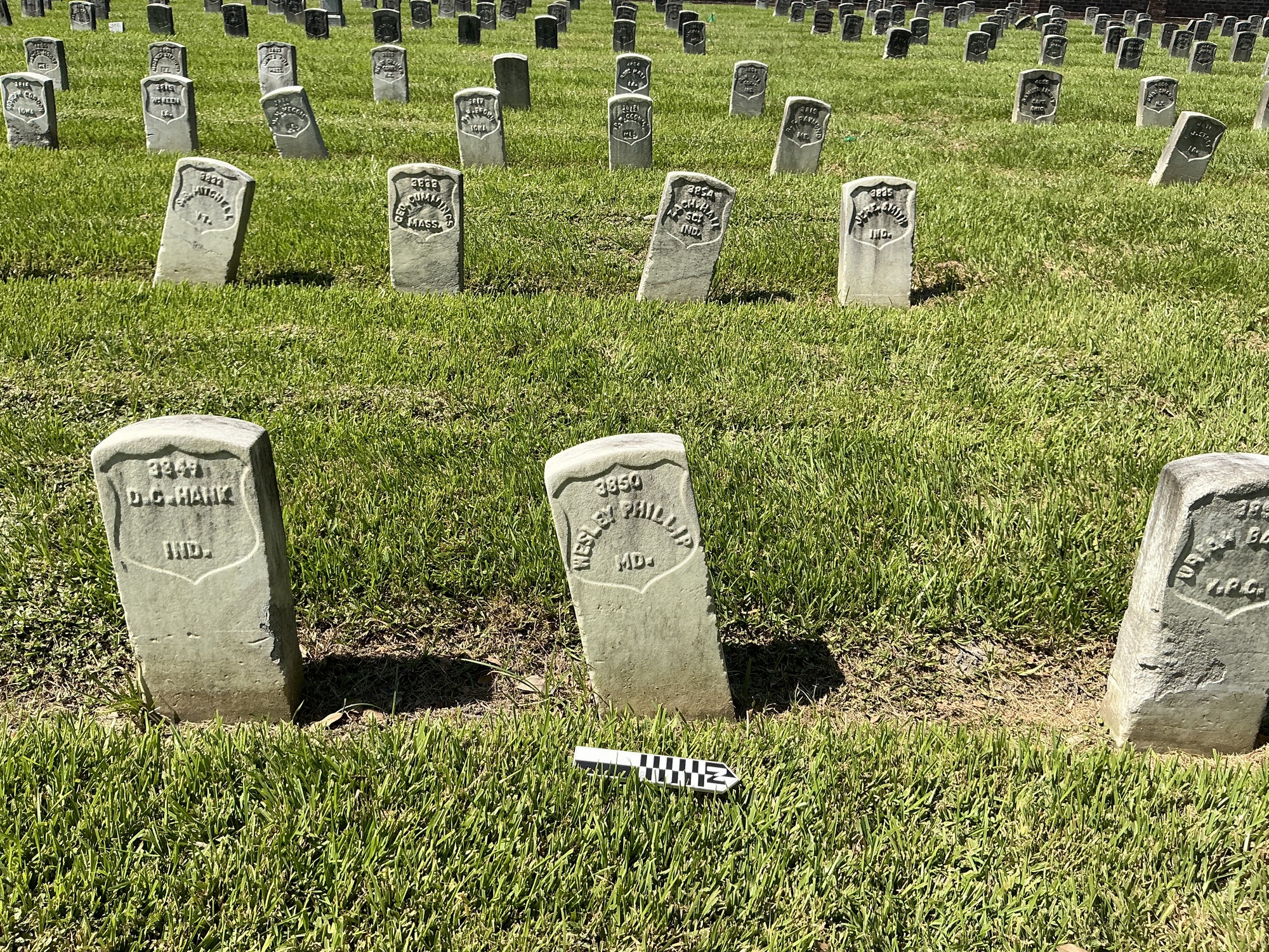 Extra image of historic upright marble headstone with recessed shield face.
