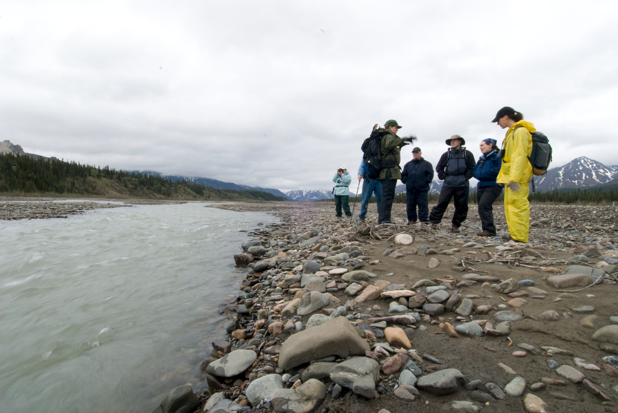 people standing near a river