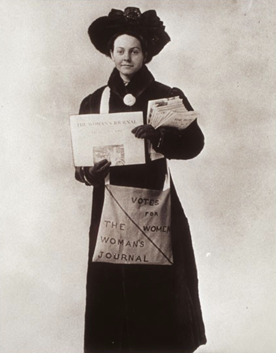 Florence Luscomb standing holding a copy of The Woman's Journal, 1911