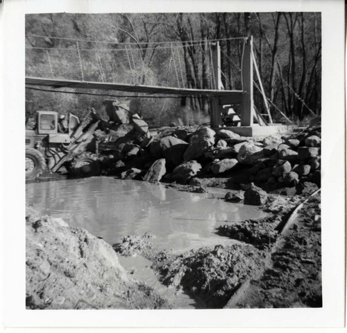 Protection/stabilization of the footings for the old Birch Creek suspension footbridge.