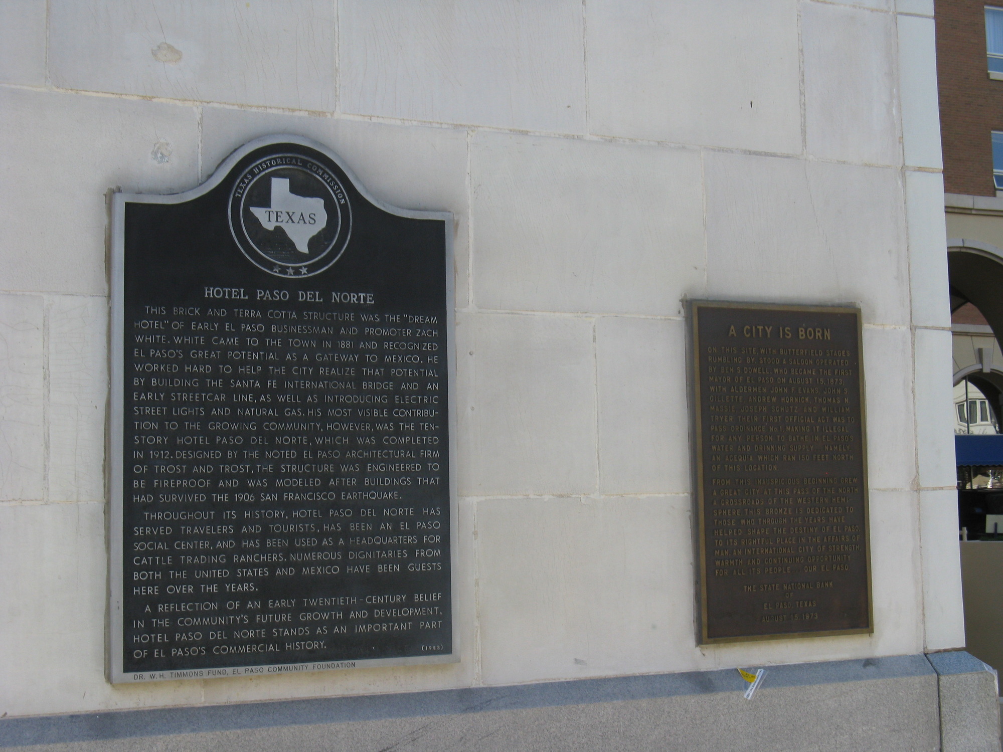 Two plaques on the side of a building.