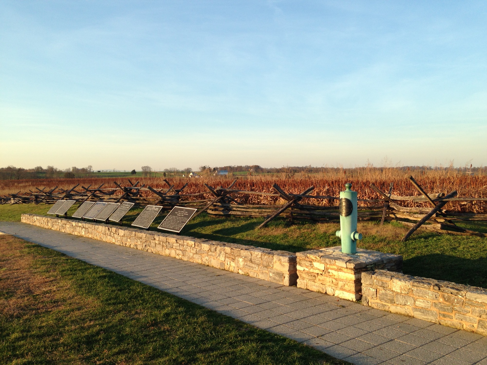 stone walk way descriptional markers fence line  