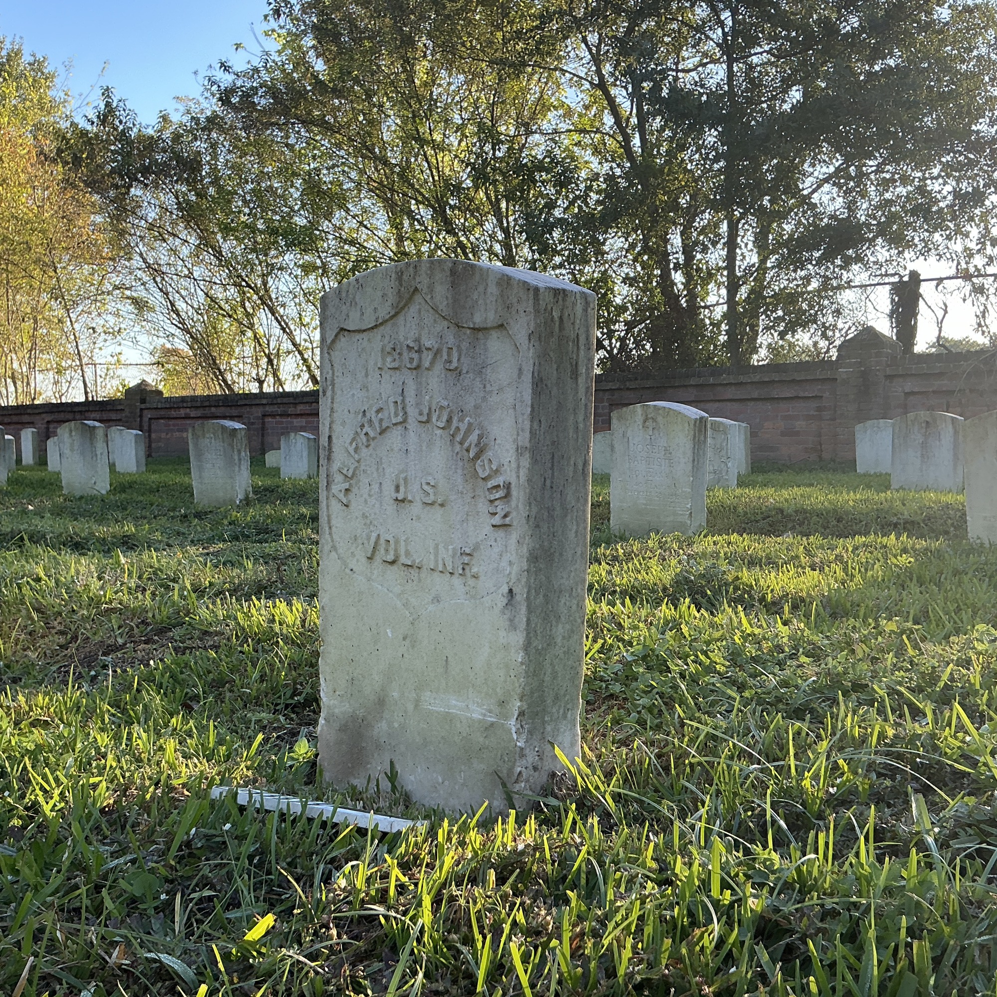 Extra image of historic upright marble headstone with recessed shield face.
