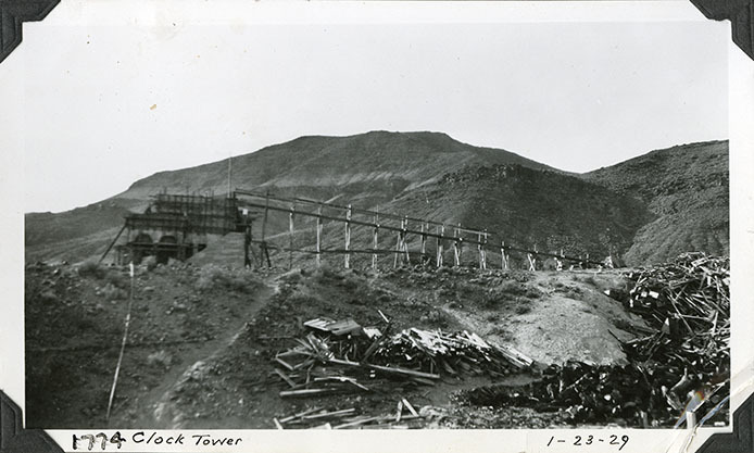 This is an historic black and white photograph from the Scotty's Castle Historic Photograph Collection, Death Valley National Park of Scotty's Castle Chimes Tower east facade, arcade arches and stairway in place. January 23, 1929. Photographed by Mat Roy Thompson.