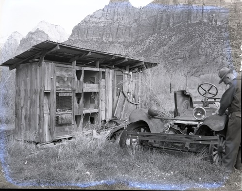 Ranger at the Samuel Heber and Mildred C. Crawford property east of Virgin River, south of park boundary, with rabbit hutch.