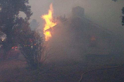 Night photos of a house burning during the Long Mesa fire in Mesa Verde National Park, July-August 2002