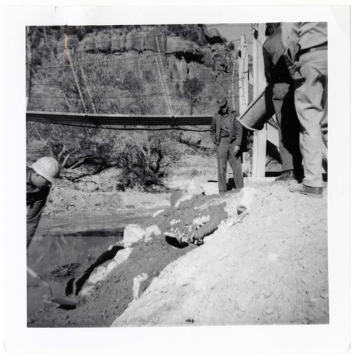 Workers during the protection/stabilization of the footings for the old Birch Creek suspension footbridge.