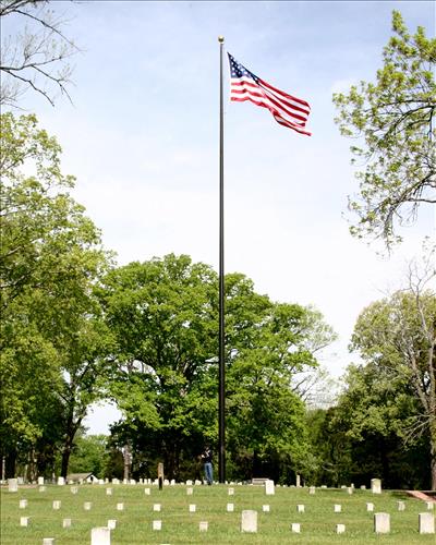 Park ranger in Civil War Union soldier costume poses in Shiloh National Cemetery