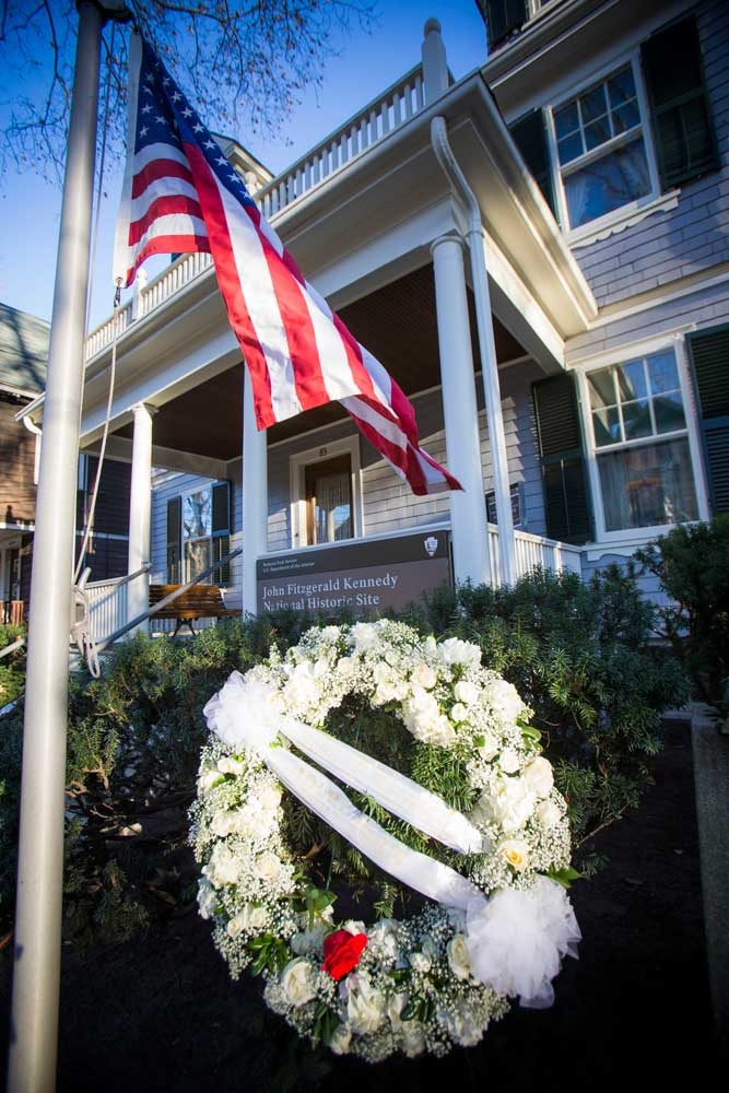 A wreath of white flowers honors John F. Kennedy at his birthplace, 83 Beals Street Brookline.