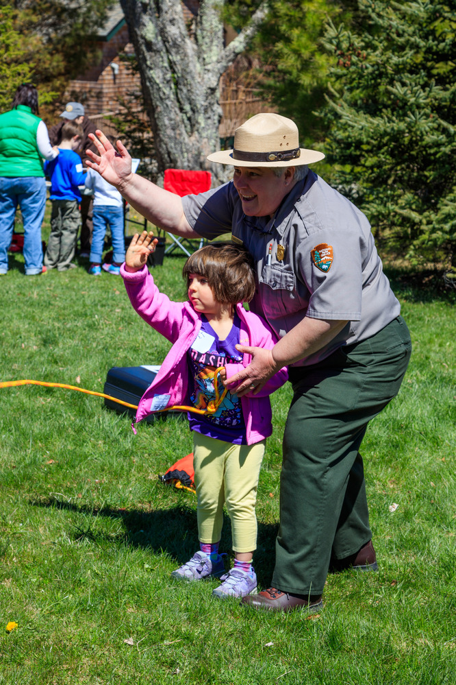 A child and ranger tossing a throw bag.