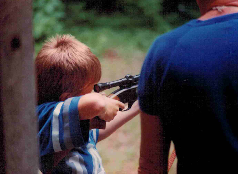 boy learning to shoot a rifle
