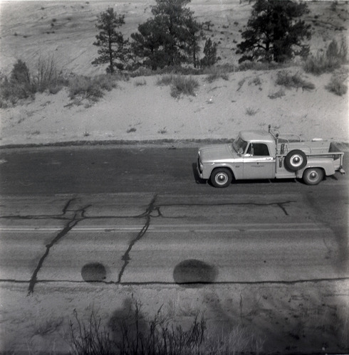 Truck driving on road during east side road repair and turn out construction.