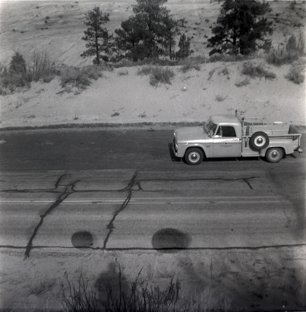 Truck driving on road during east side road repair and turn out construction.