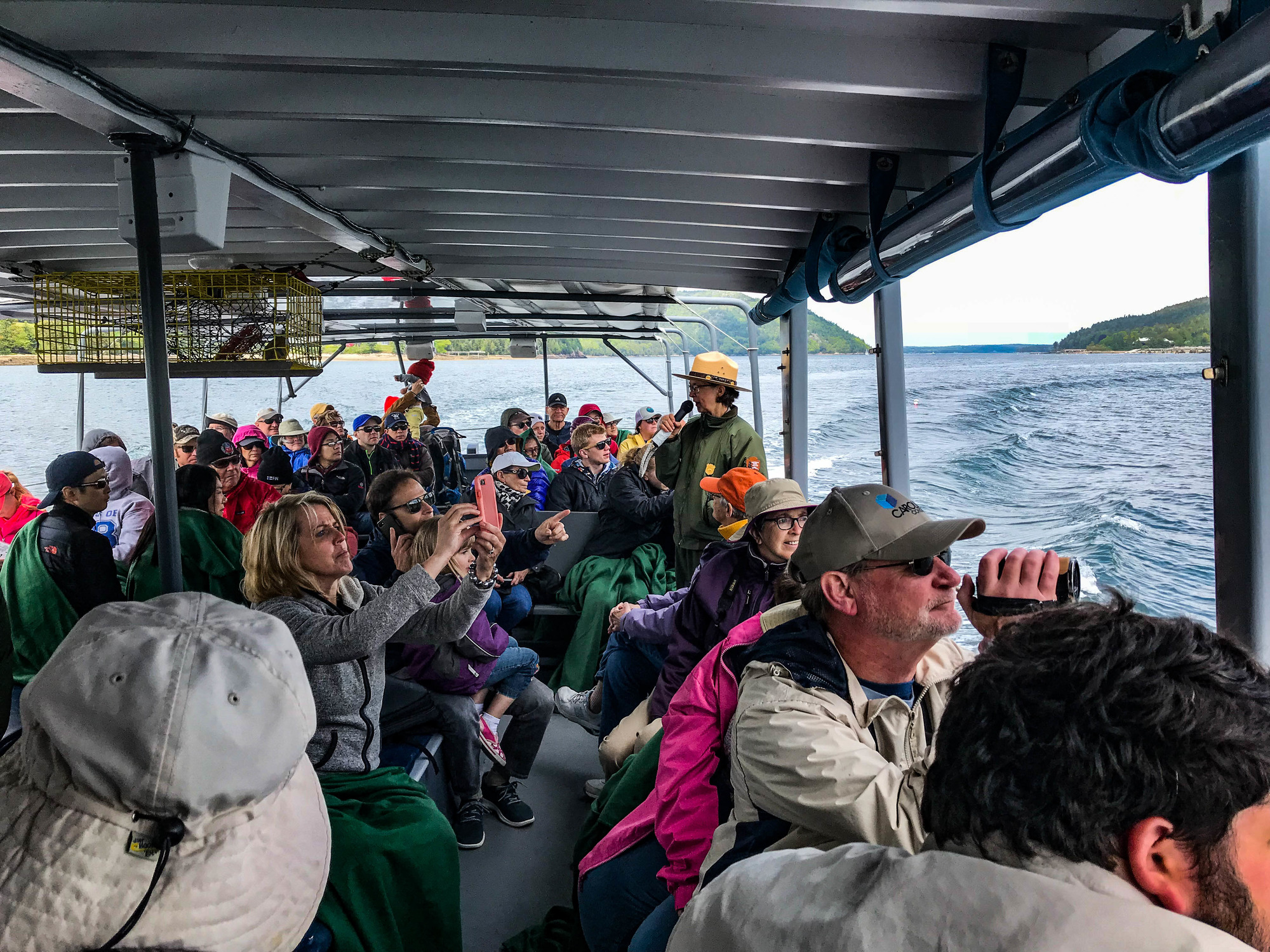 Ranger giving a tour to a large group on a boat