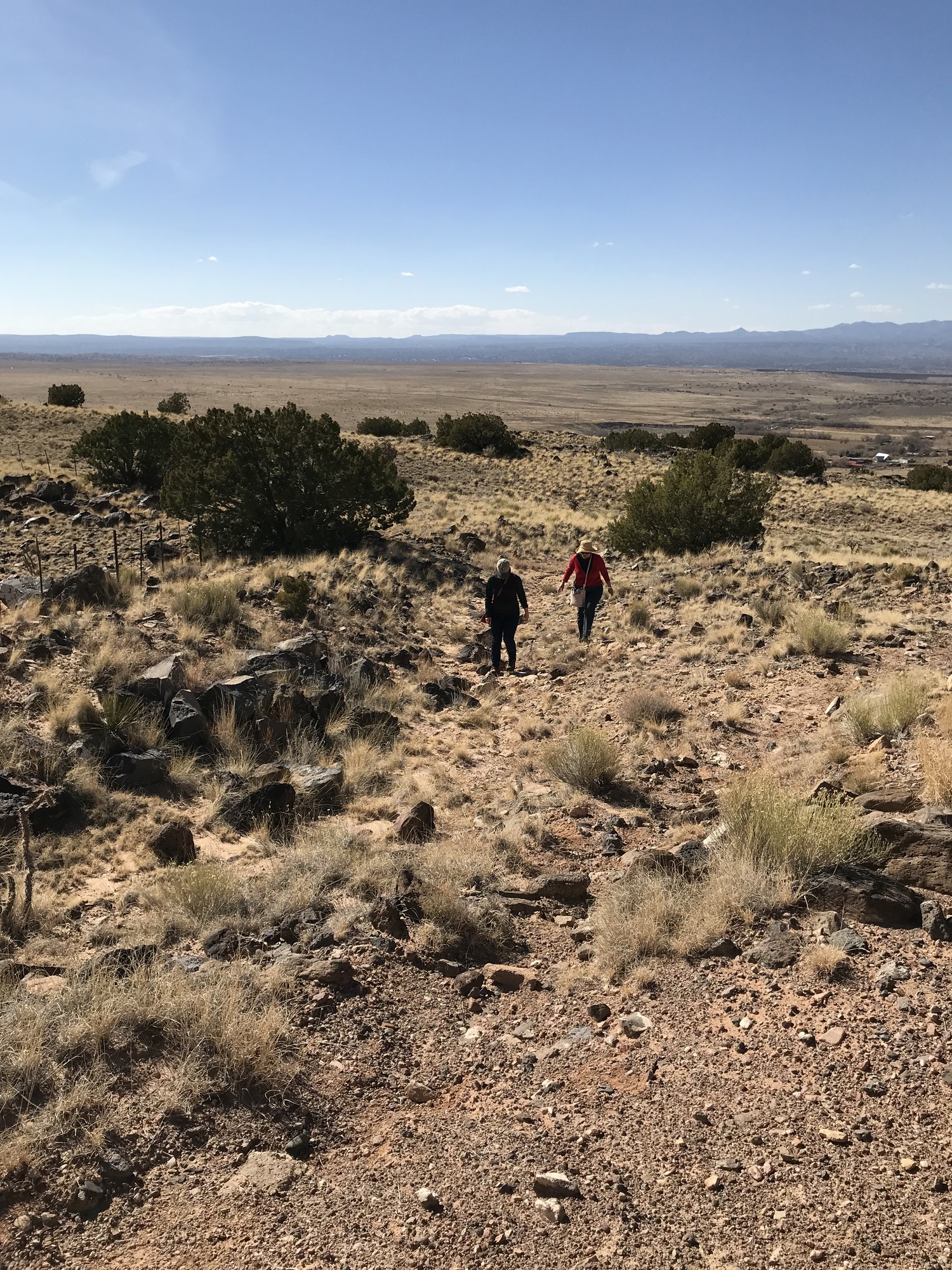 Hikers traverse the ruts and swales of La Bajada Mesa outside Santa Fe, NM
