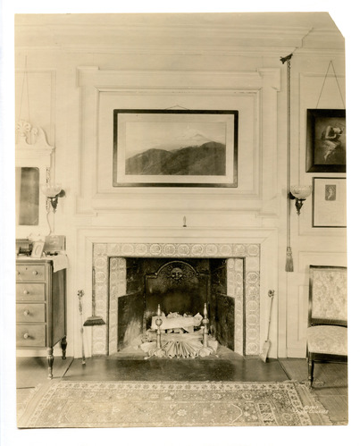 Black and white photograph of fireplace in 19th century bedroom.