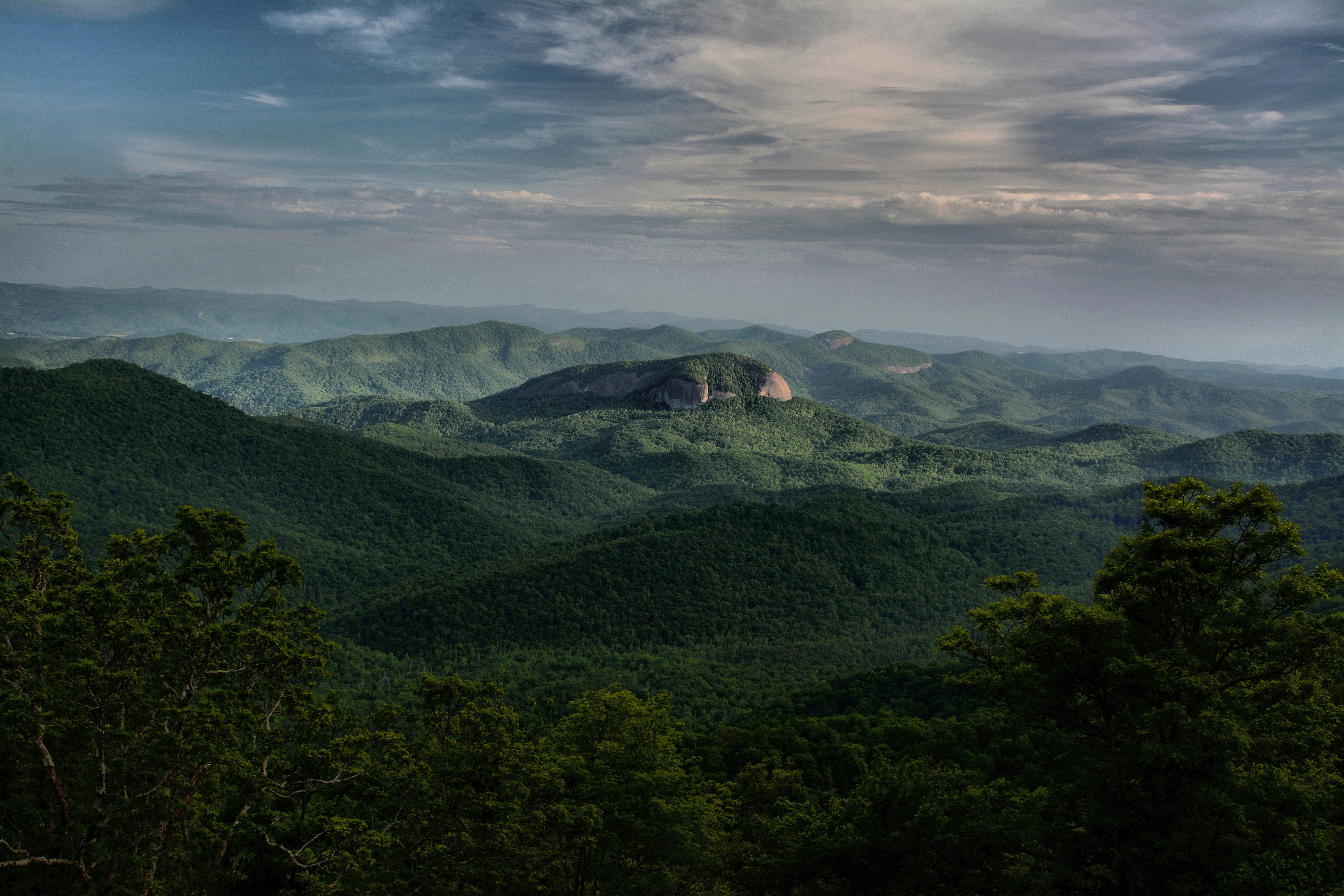 Mountains with sunlight illuminating bare rock face