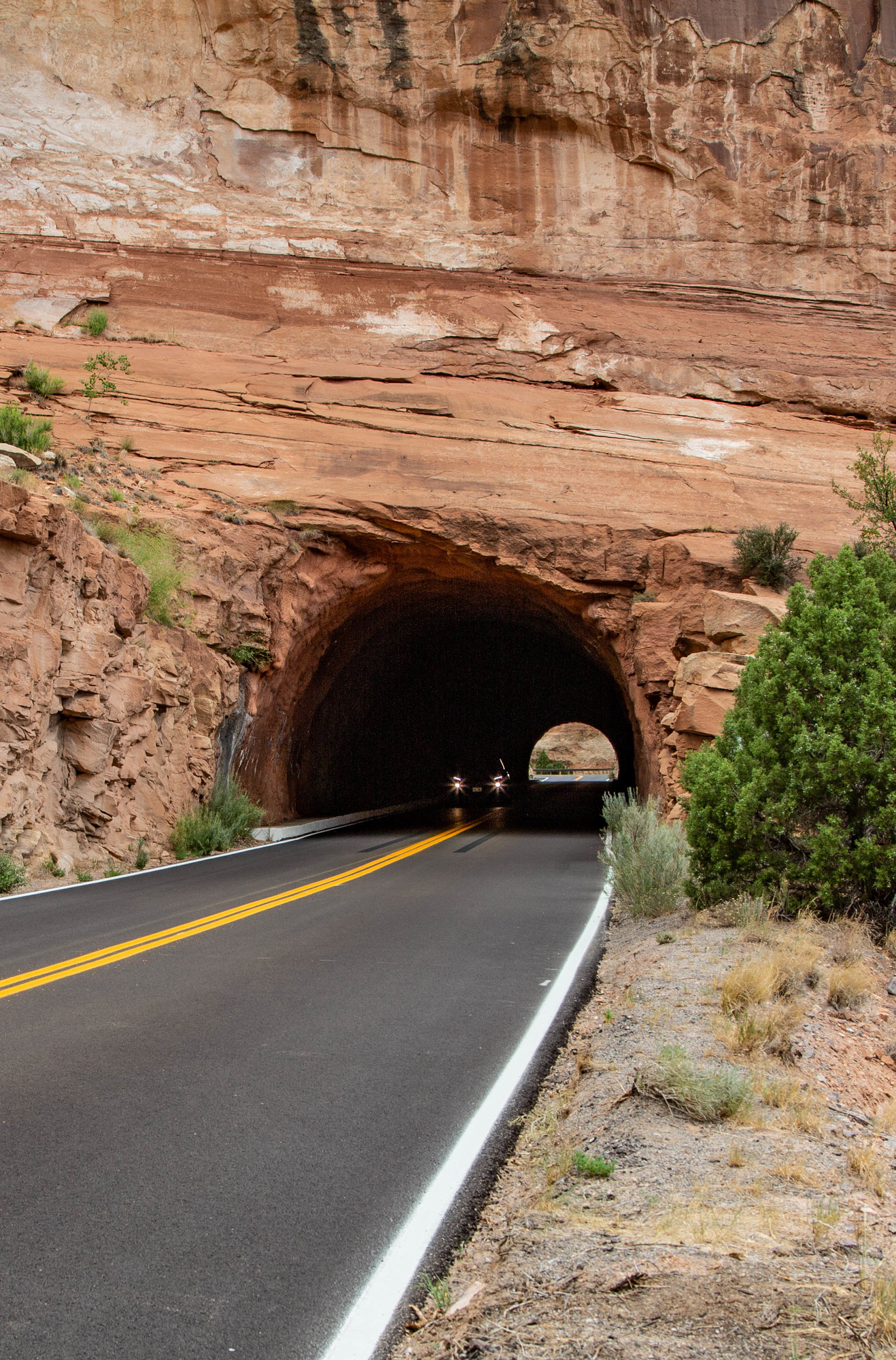 Car driving through a tunnel in a canyon wall