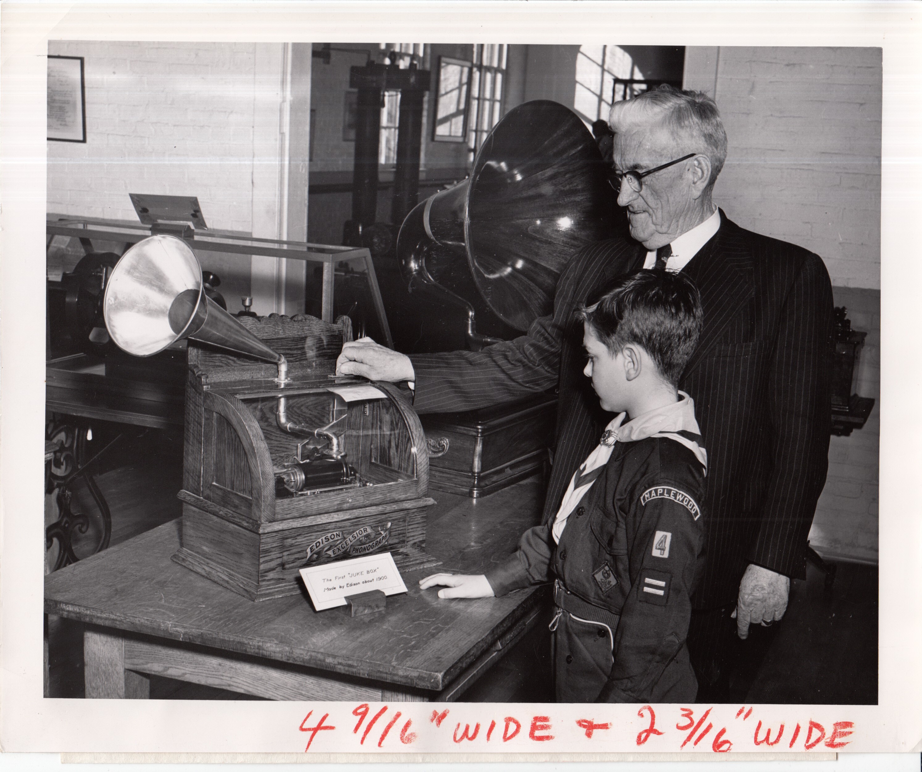 Museum staff member playing Edison Excelsior phonograph for cub scout at Edison Museum.