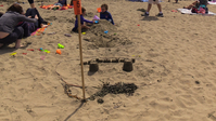 A sand castle with small buildings.