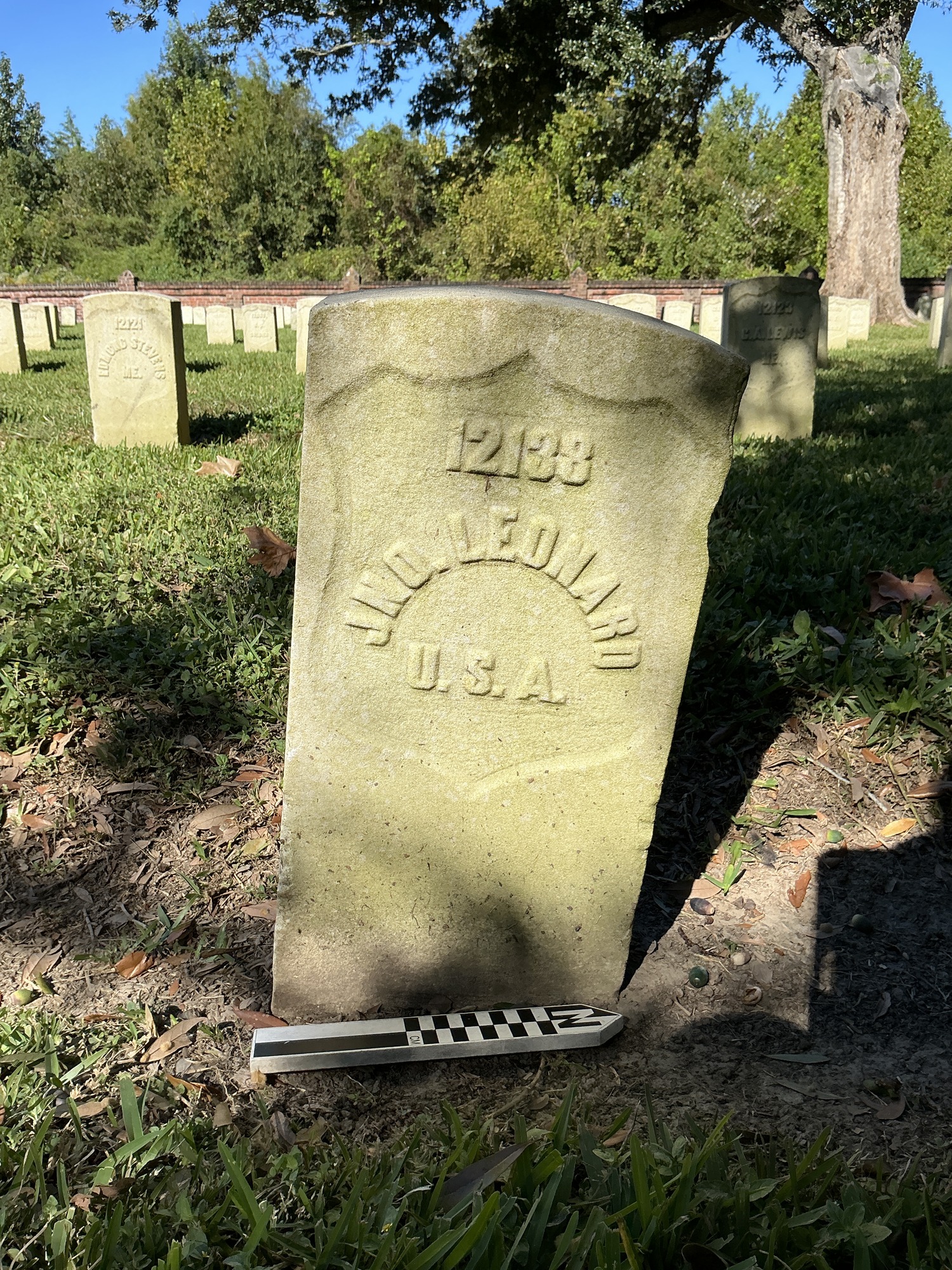 Extra image of historic upright marble headstone with recessed shield face.
