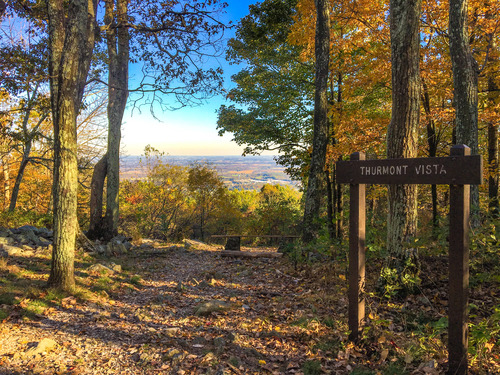 Sign for "Thurmont Vista" and bench at a mountain overlook